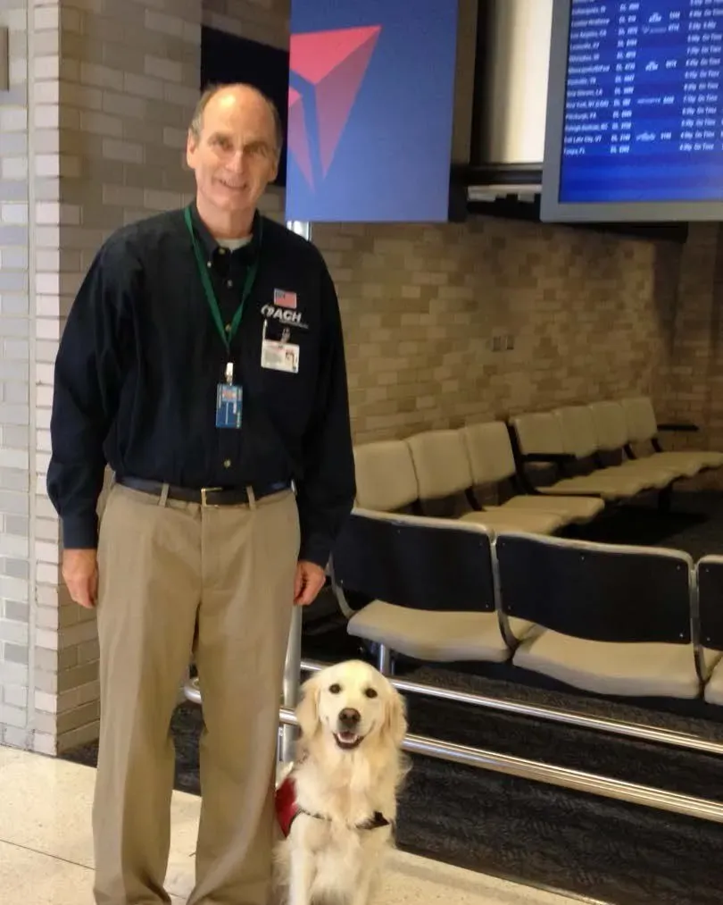 Tessa, a golden retriever, with her handler Pete at Memphis International Airport